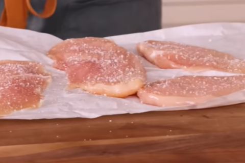 Seasoning boneless skinless chicken breasts with kosher salt and black pepper
