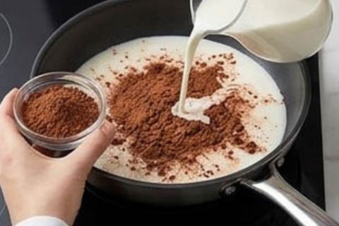 Whisking vanilla ice cream base in a glass bowl