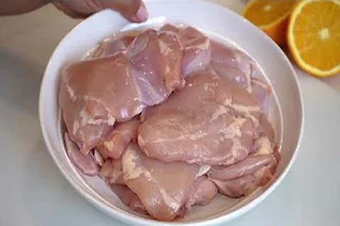 Prepping and marinating chicken pieces in a bowl