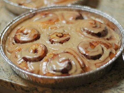Warm cinnamon rolls heavily drizzled with maple coffee icing