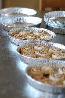Cinnamon rolls rising in a round cake pan