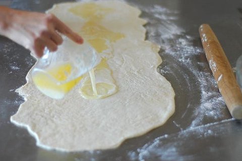 Rolling the cinnamon sugar dough into a tight, long log