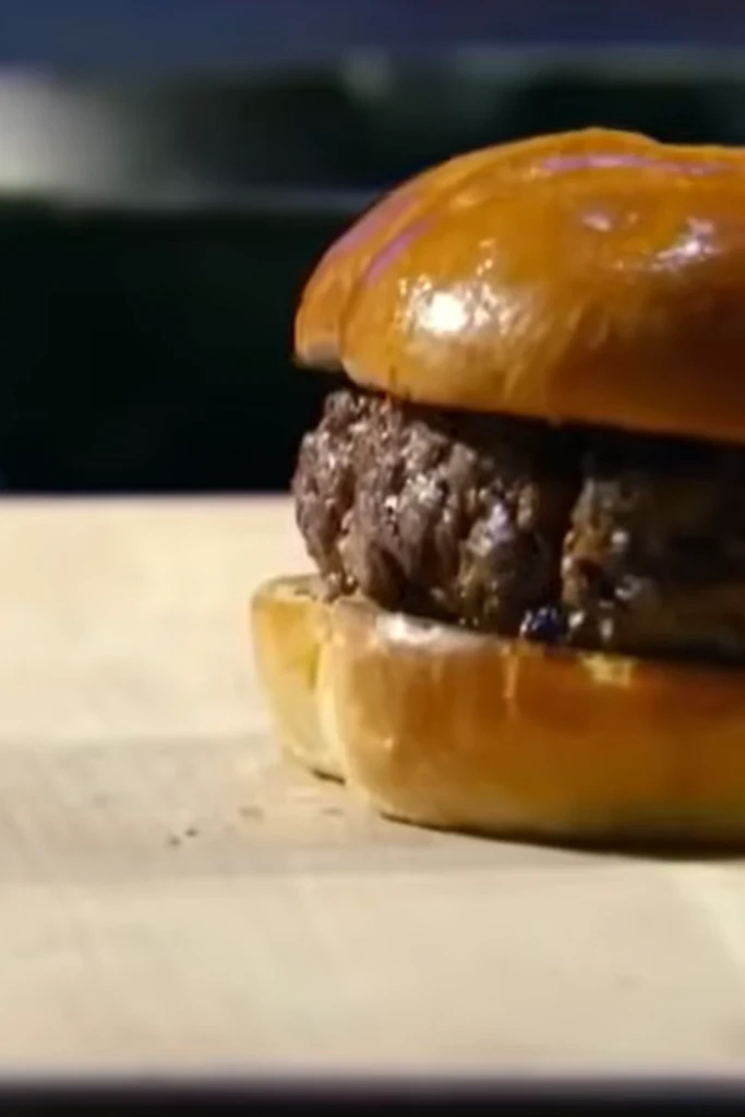 Juicy Gordon Ramsay burger on brioche bun for Pinterest recipe save